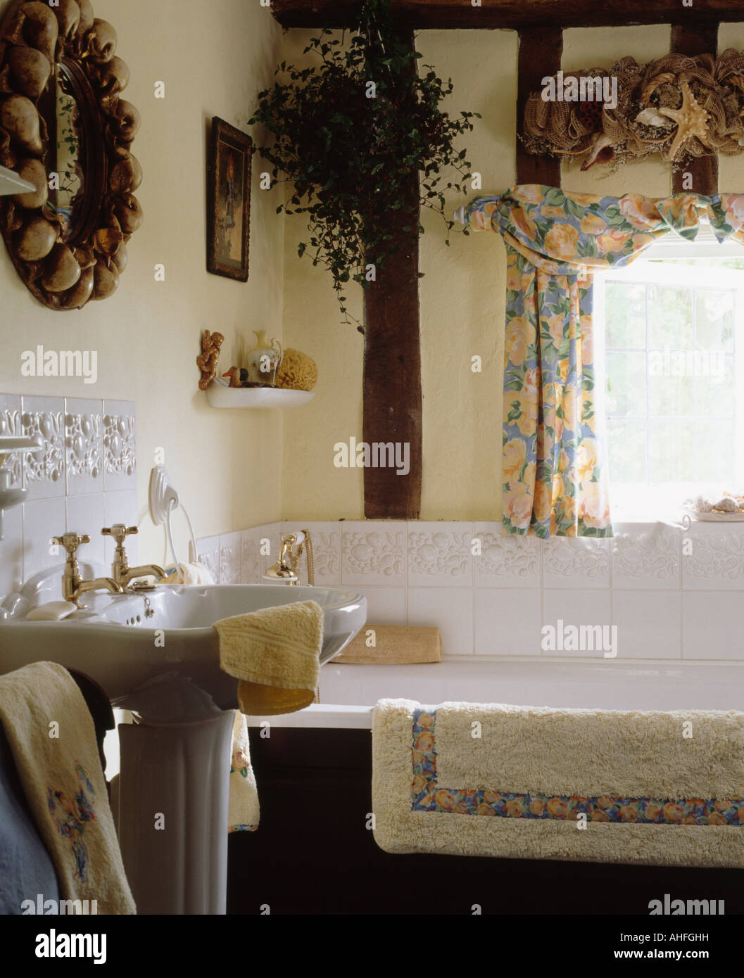 Patterned curtains above bathtub in small cottage bathroom with white