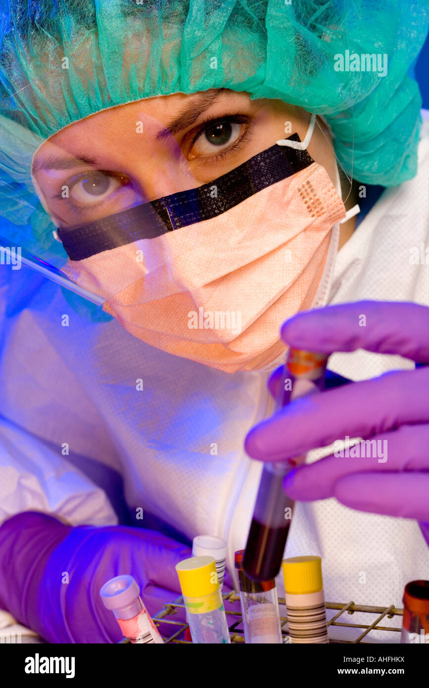 Female lab tech with face mask and test tubes Stock Photo Alamy