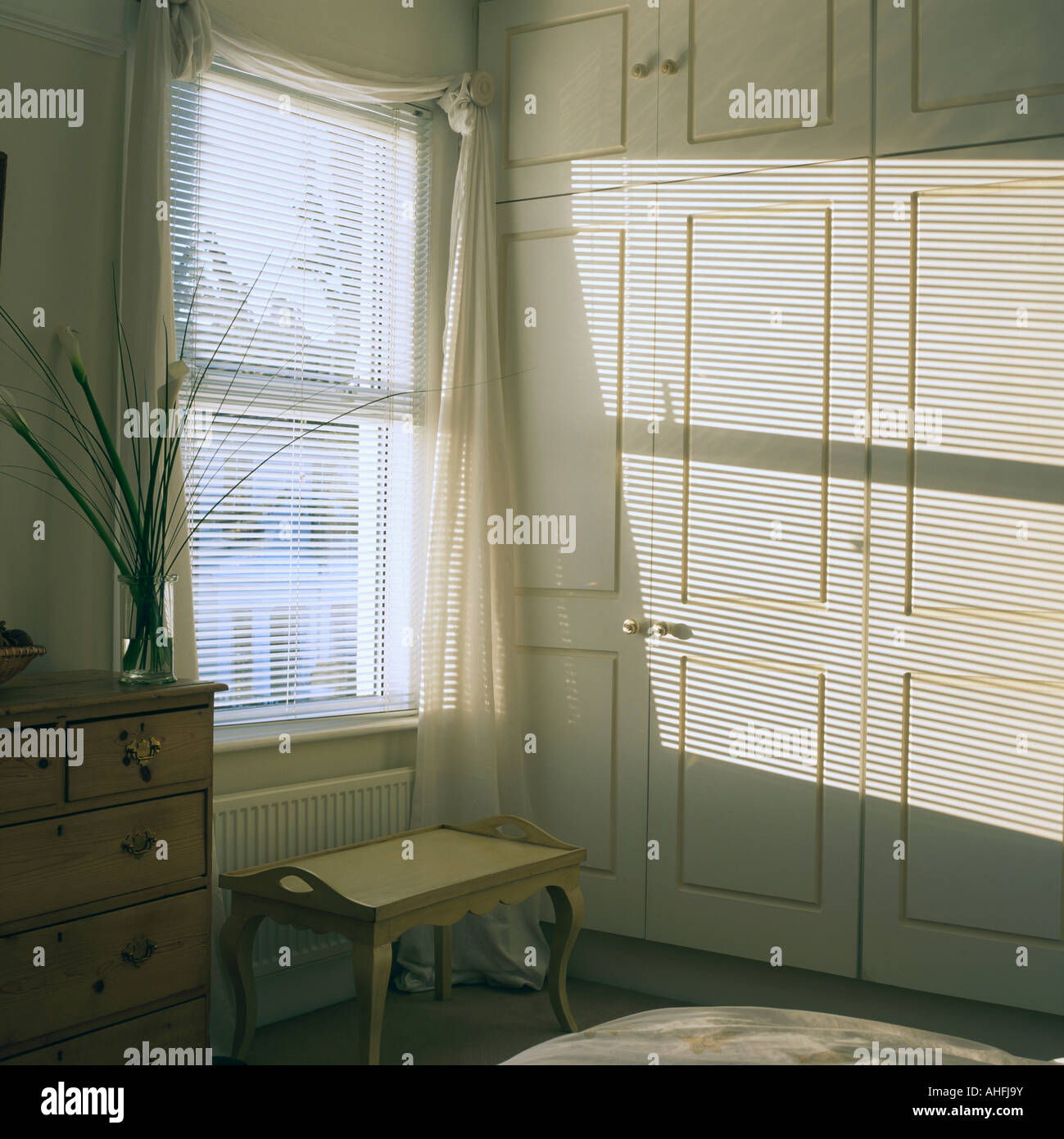 blind in bedroom with fitted cupboards Stock Photo Alamy