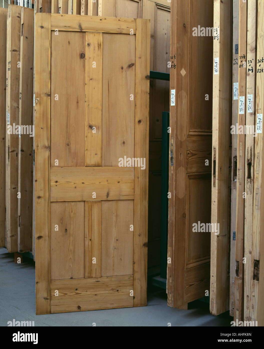 Old wooden doors for sale in reclamation showroom Stock Photo - Alamy