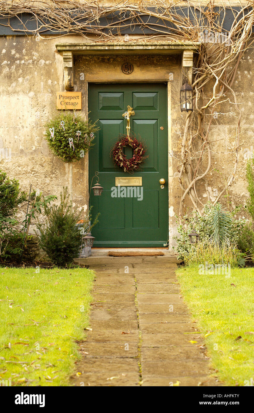 Stone path to green front door with Christmas wreath on English country house Stock Photo