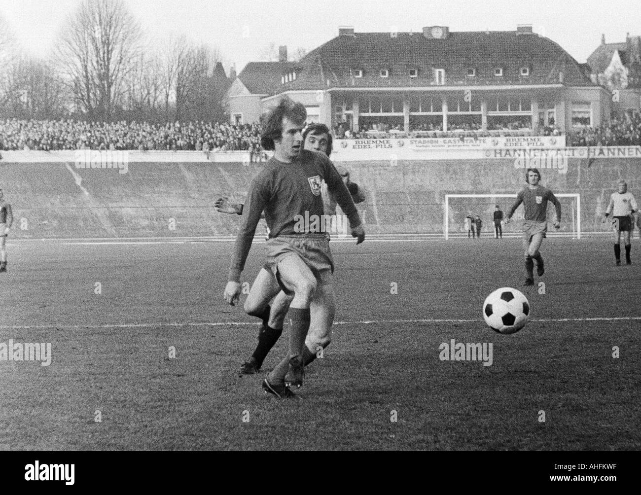 football, Regionalliga West, 1971/1972, Stadium am Zoo in Wuppertal, Wuppertaler SV versus Alemannia Aix-La-Chapelle 5:0, scene of the match, duel between Gustav Jung (WSV) ahead an an Aachen player, right behind Guenter Proepper (WSV), in the background Stock Photo