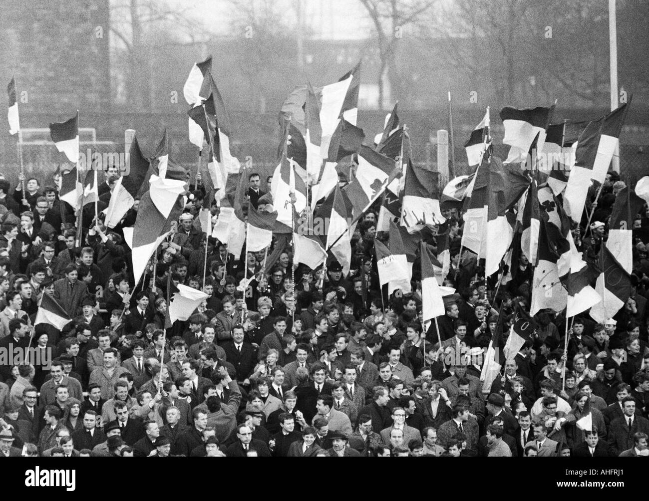 football, Regionalliga West, 1967/1968, Niederrhein Stadium in Oberhausen, Rot-Weiss Oberhausen versus Preussen Muenster 1:0, crowd of spectators, Oberhausen football fans rejoicing about a goal and wave the club flags Stock Photo