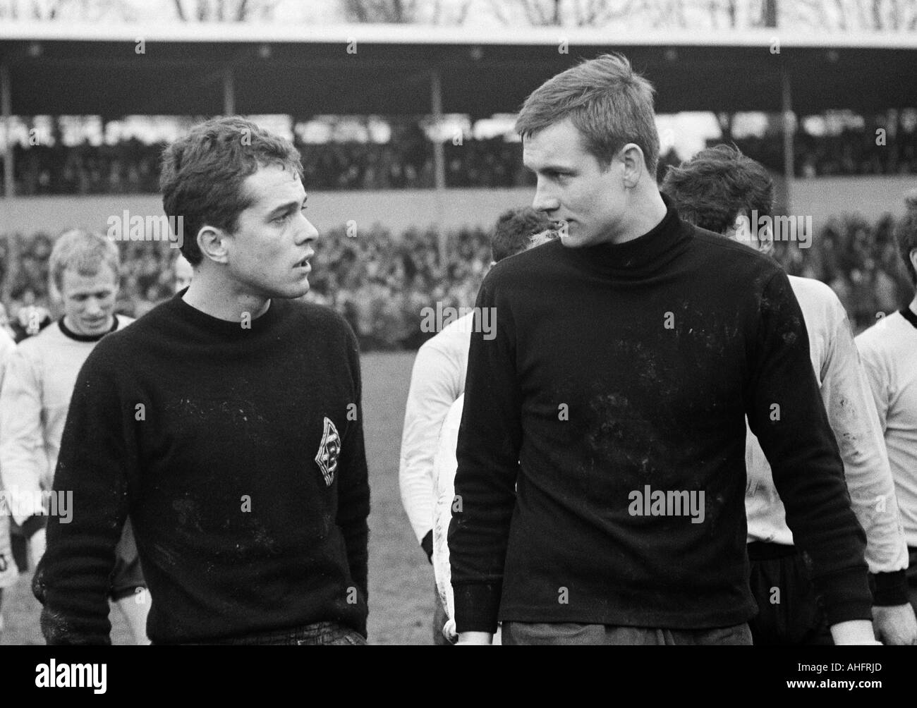 football, Bundesliga, 1967/1968, Borussia Dortmund versus Borussia Moenchengladbach 3:1, Rote Erde Stadium, football players leaving the pitch, keepers Volker Danner (MG) left and Werner Koeddermann (BVB) talking, left behind Siegfried Held (BVB) Stock Photo