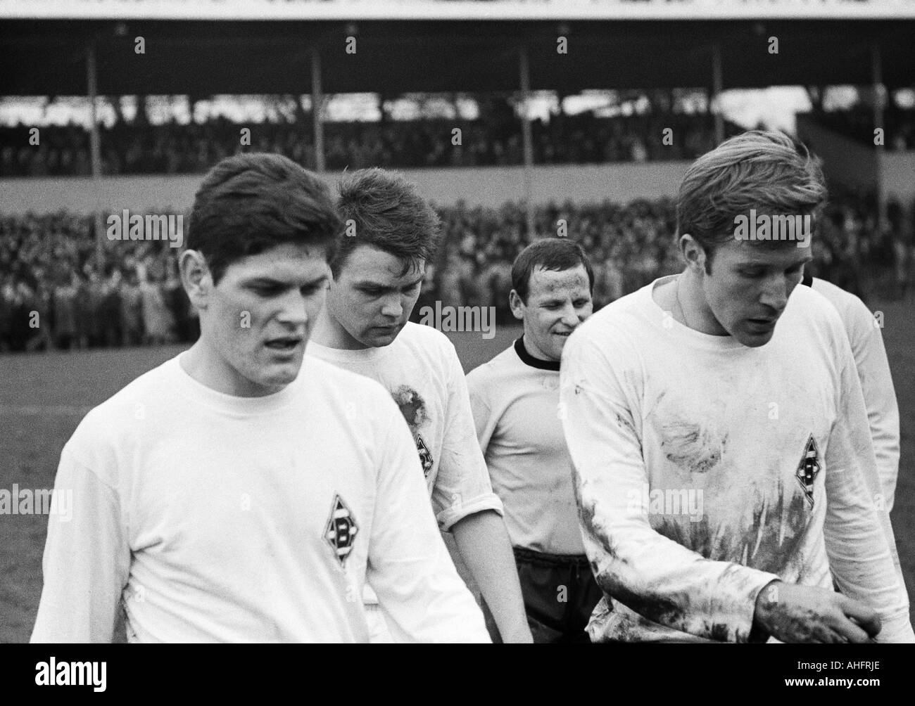 football, Bundesliga, 1967/1968, Borussia Dortmund versus Borussia Moenchengladbach 3:1, Rote Erde Stadium, football players leaving the pitch, f.l.t.r. Heinz Wittmann (MG), Herbert Laumen (MG), Dieter Kurrat (BVB), Guenter Netzer (MG) Stock Photo