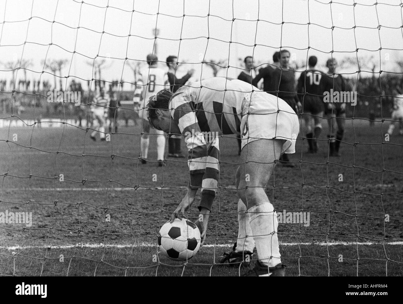football, Bundesliga, 1967/1968, Wedau Stadium in Duisburg, MSV Duisburg versus 1. FC Kaiserslautern 7:0, scene of the match, 7:0 free-kick goal to MSV by Horst Wild (not pictured), Rainer Budde (MSV) fetches the ball out of the net Stock Photo