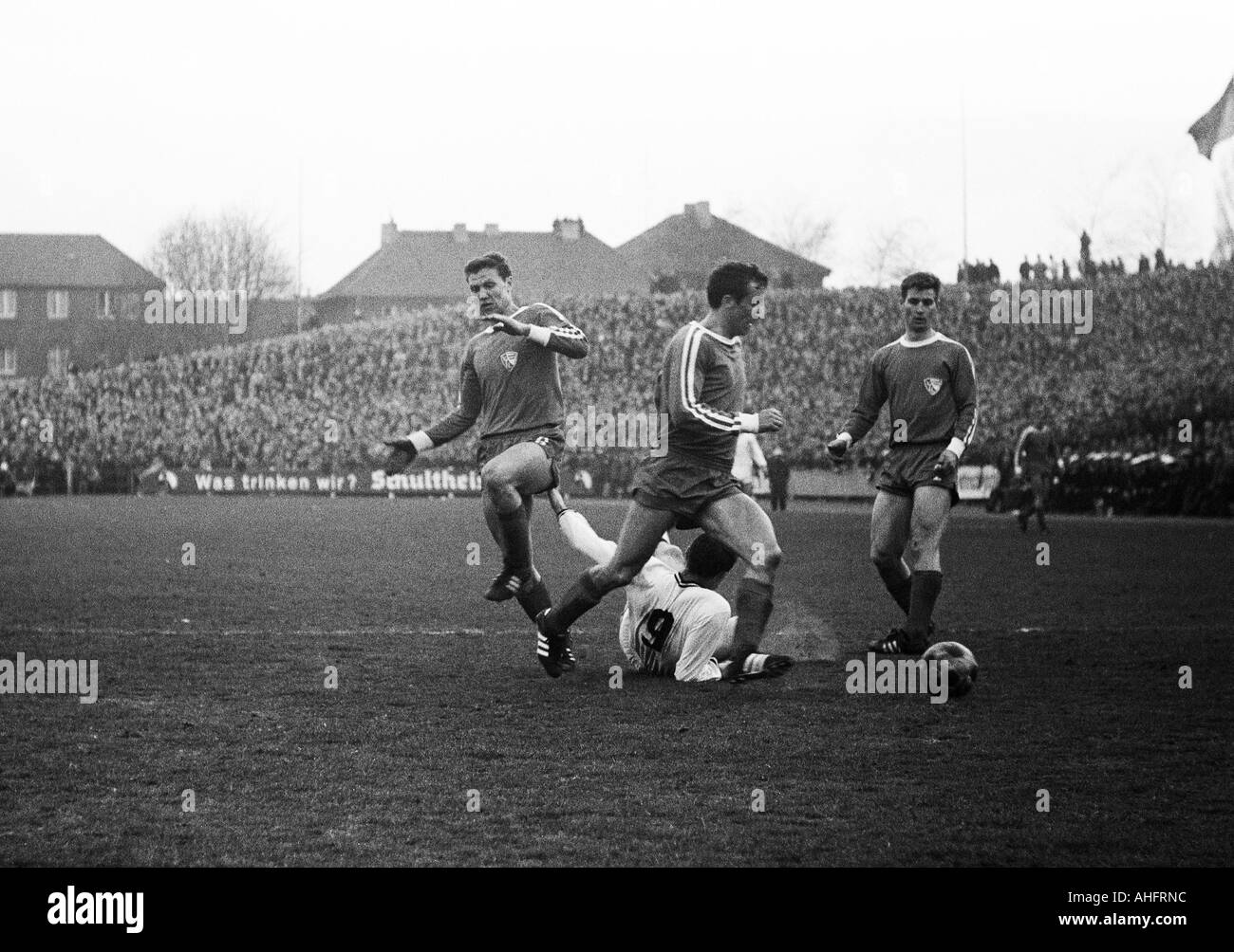 football, DFB Cup, quarter final, 1967/1968, Ruhr Stadium in Bochum, VfL Bochum versus Borussia Moenchengladbach 2:0, scene of the match, f.l.t.r. Erwin Galeski (Bochum), Erich Schiller (Bochum), Herbert Laumen (MG) aground, Gerd Wiesemes (Bochum) Stock Photo