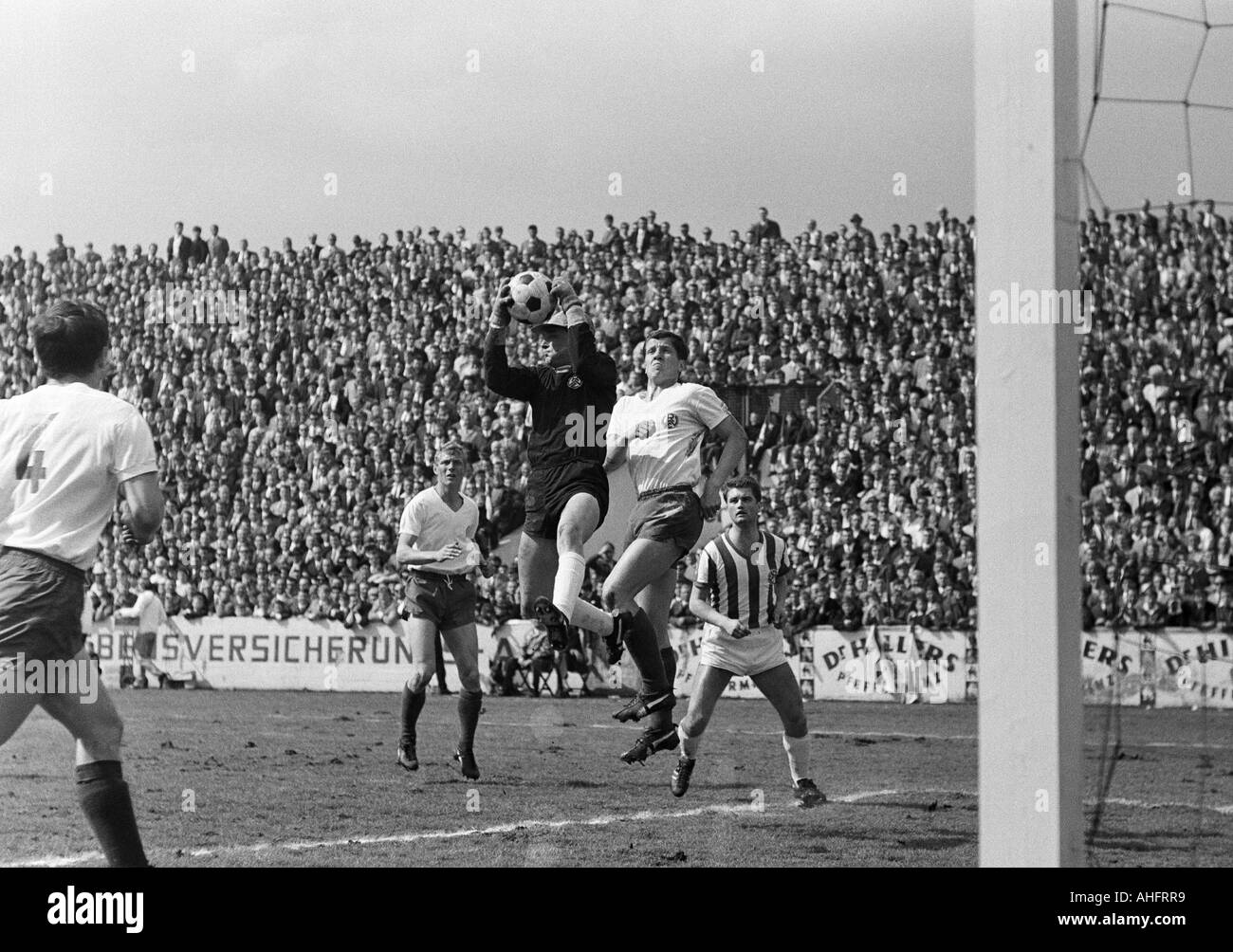 football, Regionalliga West, 1967/1968, Stadium an der Hafenstrasse in Essen, Rot-Weiss Essen versus Arminia Bielefeld 2:0, scene of the match, f.l.t.r. Roland Peitsch (RWE, 4), Heinz Stauvermann (RWE), keeper Fred Werner Bockholt (RWE), Juergen Glinka (R Stock Photo