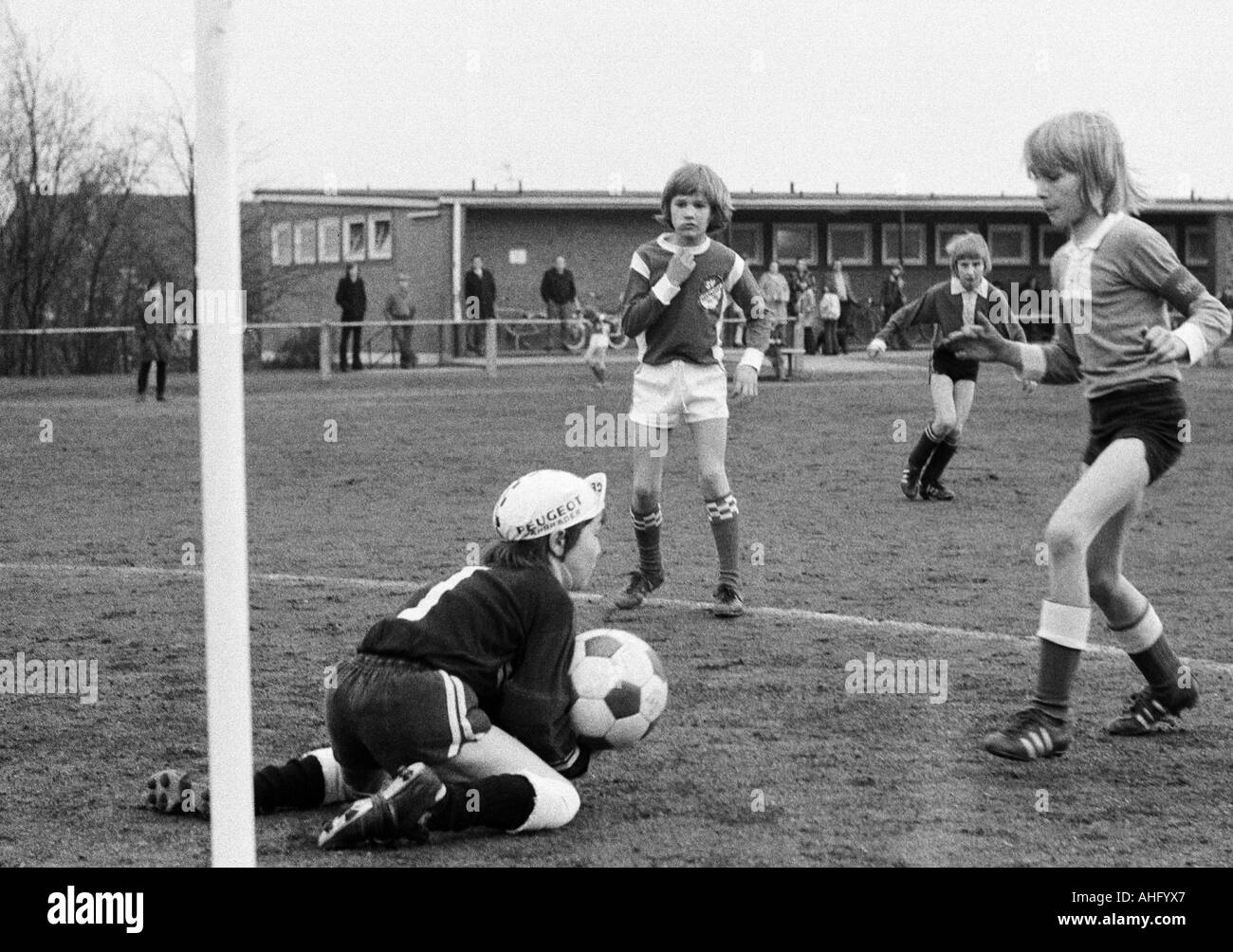 sports, football, childs, children, boys aged 8 to 10 play football, club football, Oberhausen, Ruhr area, North Rhine-Westphalia, scene of the match, keeper saves the ball Stock Photo