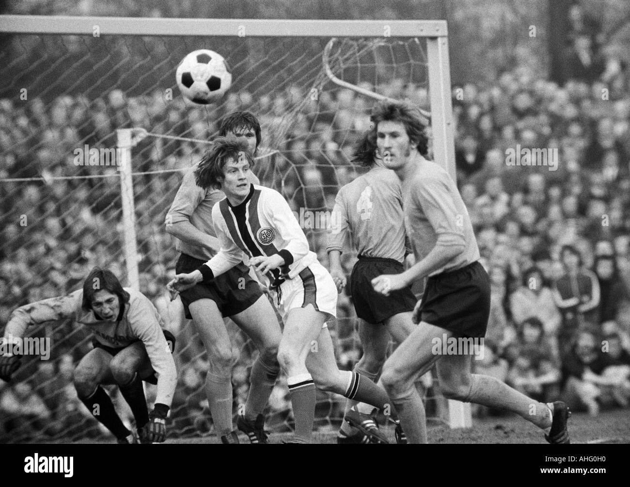 football, DFB Cup, quarter final, 1973/1974, SG Wattenscheid 09 versus Hamburger SV 0:1 after extra time, Lohrheide Stadium in Bochum-Wattenscheid, scene of the match, f.l.t.r. keeper Rudolf Kargus (HSV), Ewald Hammes (Wattenscheid), Peter Nogly (HSV) cov Stock Photo
