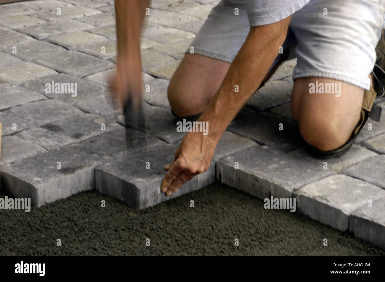 Working laying concrete pavers for patio Stock Photo
