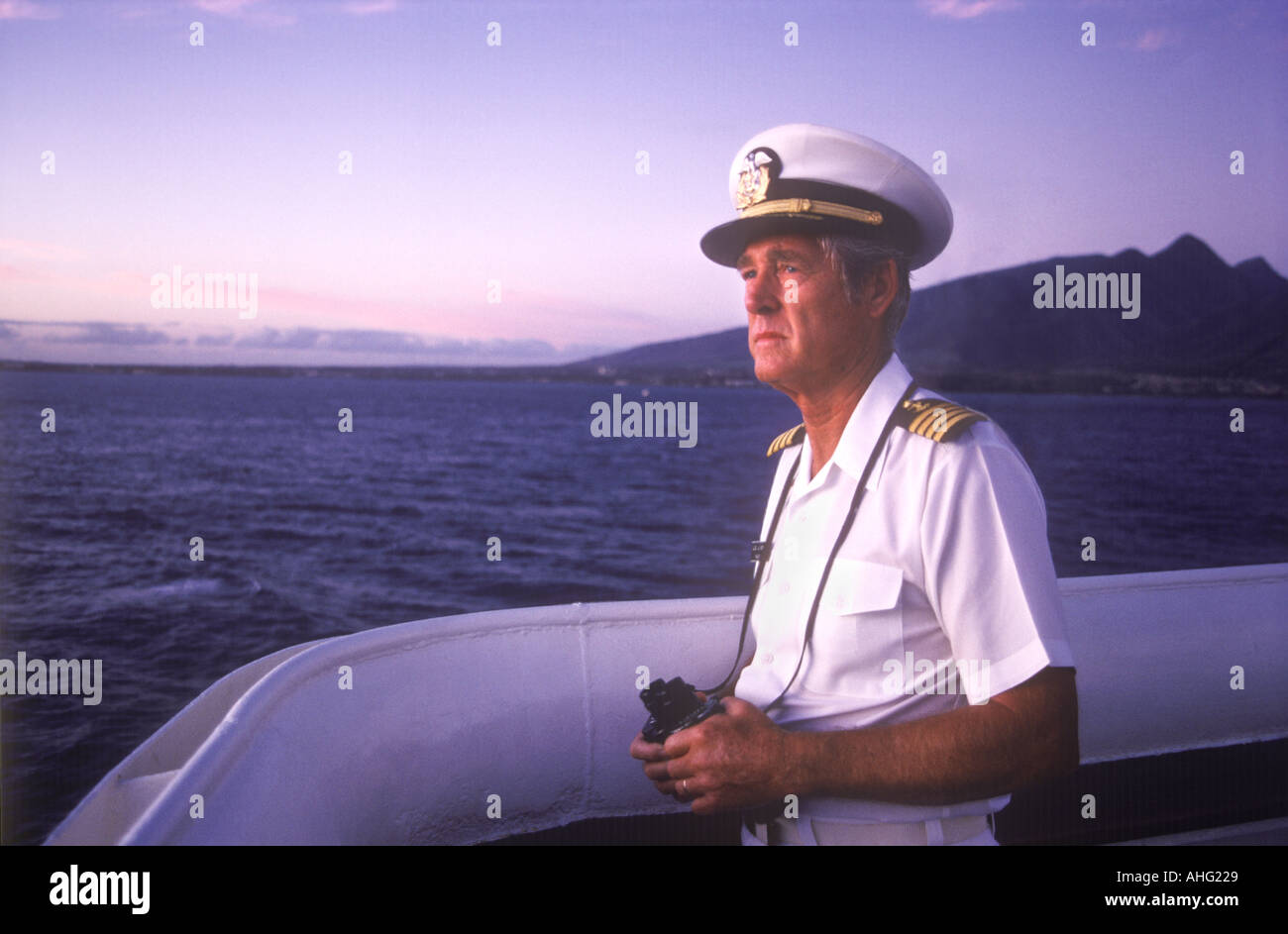 Ship Captain On Boat Bridge At Dawn With Binoculars, Hawaii, USA Stock