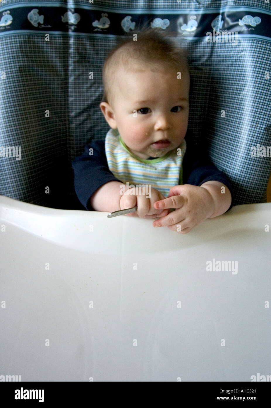 baby eating at high chair Stock Photo Alamy