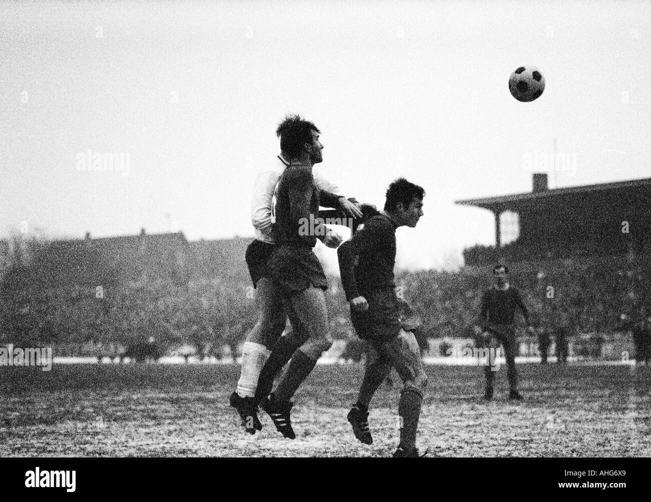 football, Bundesliga, 1969/1970, Niederrhein Stadium in Oberhausen, Rot-Weiss Oberhausen versus FC Bayern Munich 3:3, scene of the match, f.l.t.r. an Oberhausen player (covered), Peter Pumm, Franz Beckenbauer (both FCB) Stock Photo