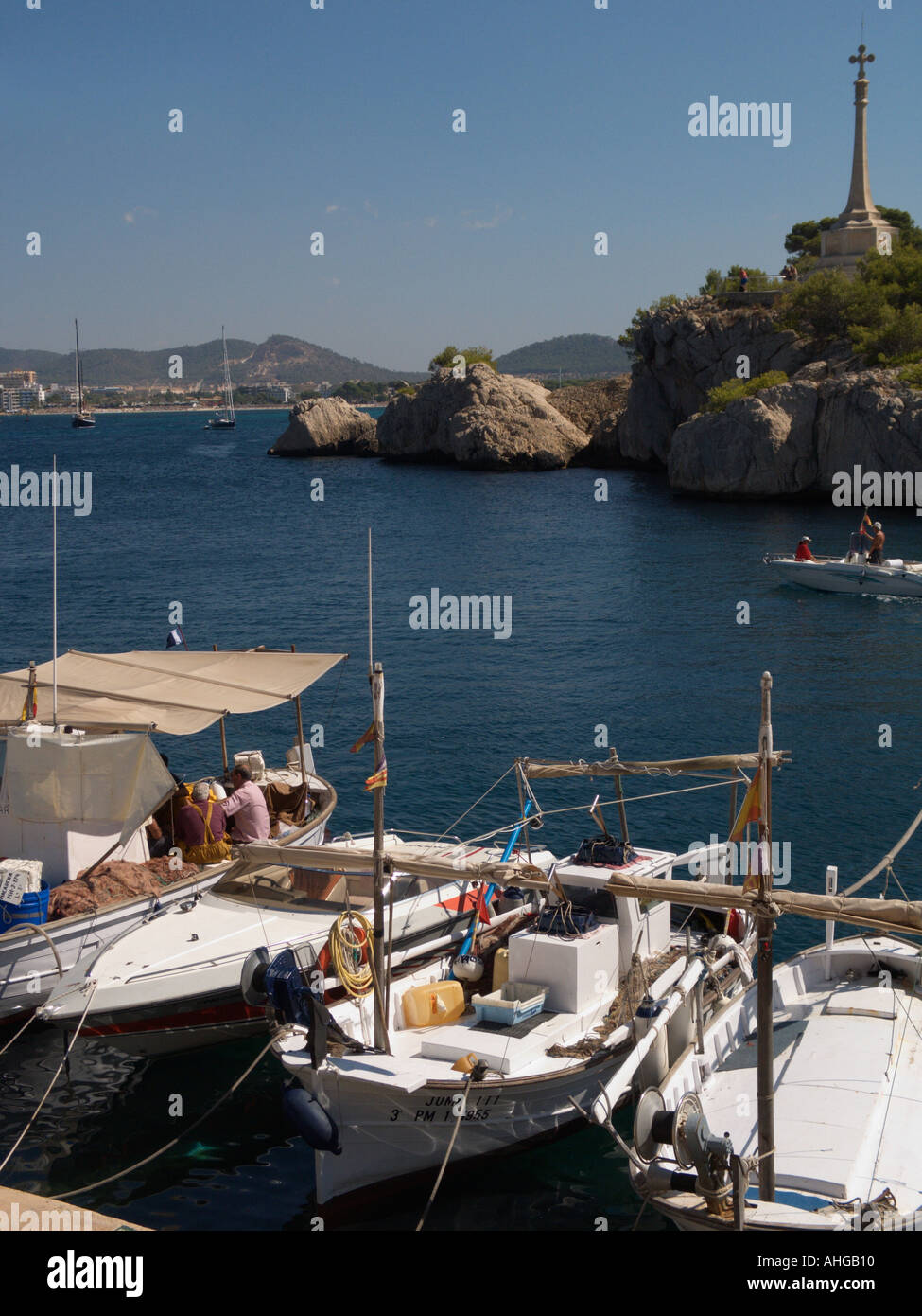 White fishing boats in Santa Ponsa Harbour and Monument, Santa Ponsa Bay, Ponent Region, Mallorca, Spain Stock Photo