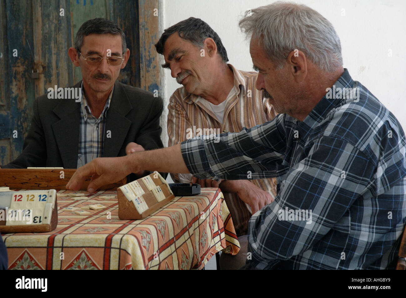 Men in small rural village of Bezirgan Southern Turkey playing game of Okay. Stock Photo