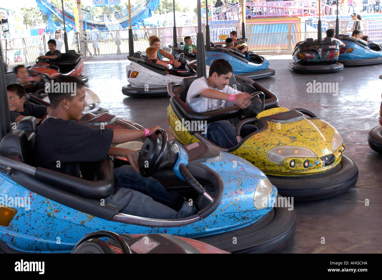 two teen age boys on Bumper cars collide at an amusement park in California Stock Photo