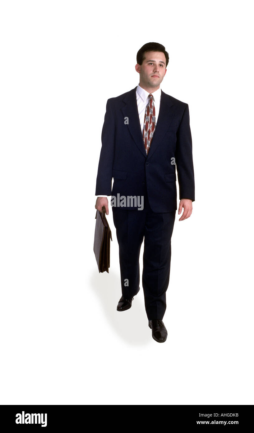 A business man walks with briefcase in studio. Stock Photo