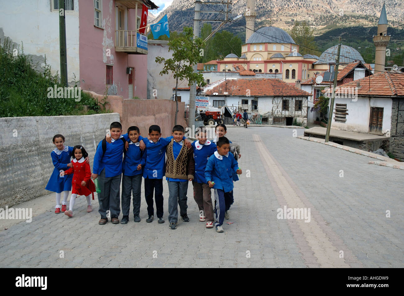 School children coming home from school in streets of village of Gombe in Anatolia Southern Turkey. Stock Photo
