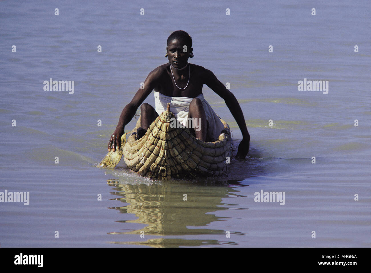 Njemps fisherman riding on his Ambach canoe on Lake Baringo in the Great Rift Valley Kenya East Africa Stock Photo