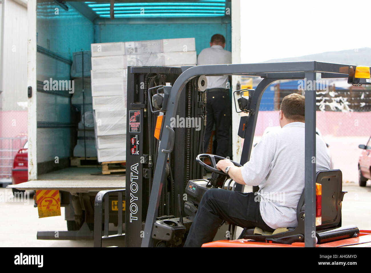 workmen unloading tail lift lorry with forklift containing pallet Stock Photo 8268732 Alamy