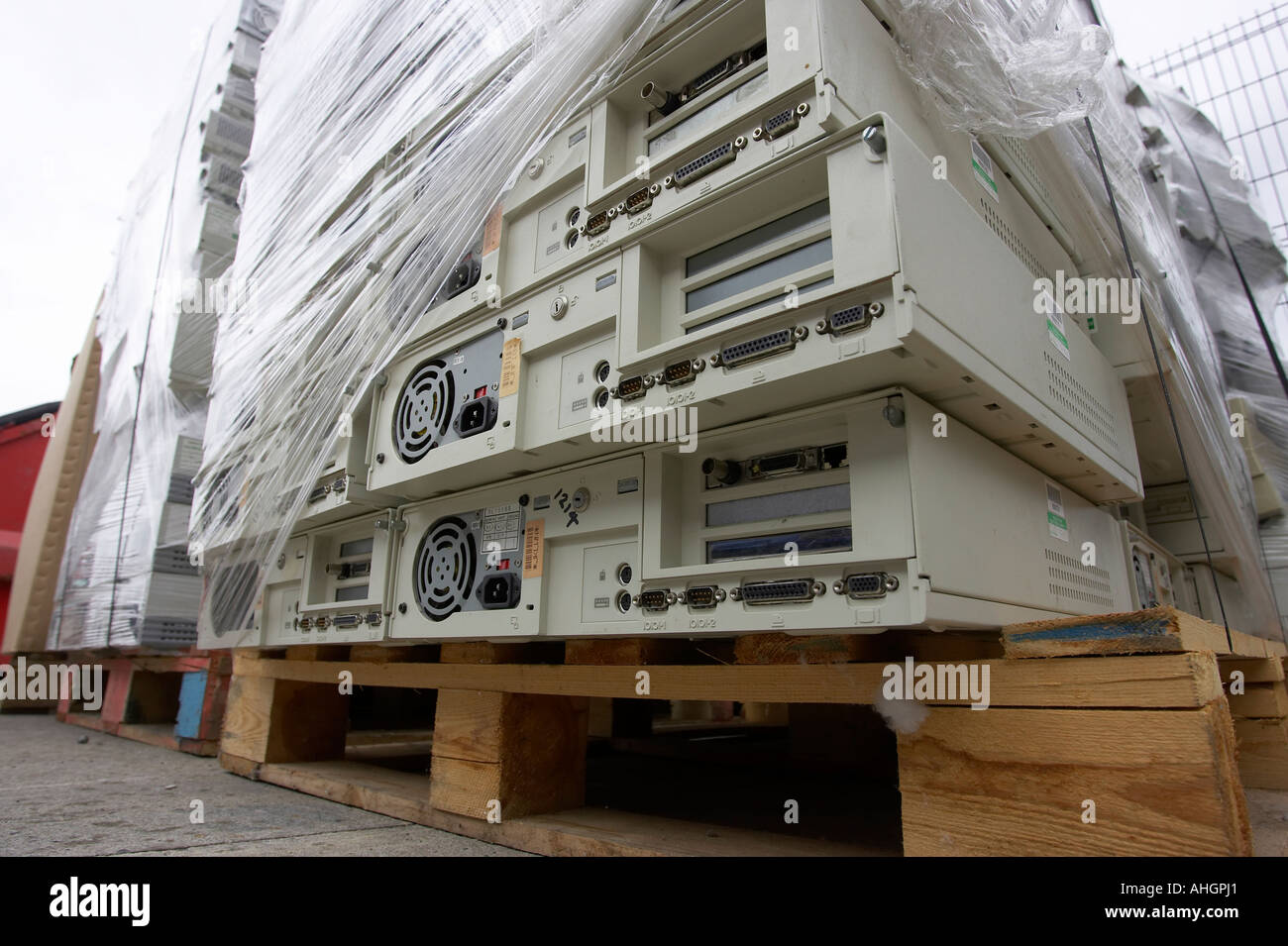 pile of computer system boxes pallet wrapped sitting on wooden pallet