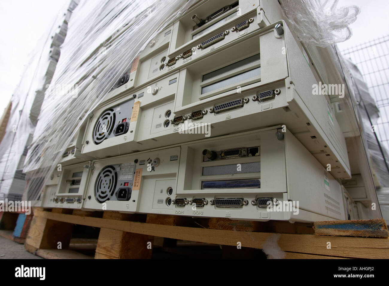 pile of computer system boxes pallet wrapped sitting on wooden pallet