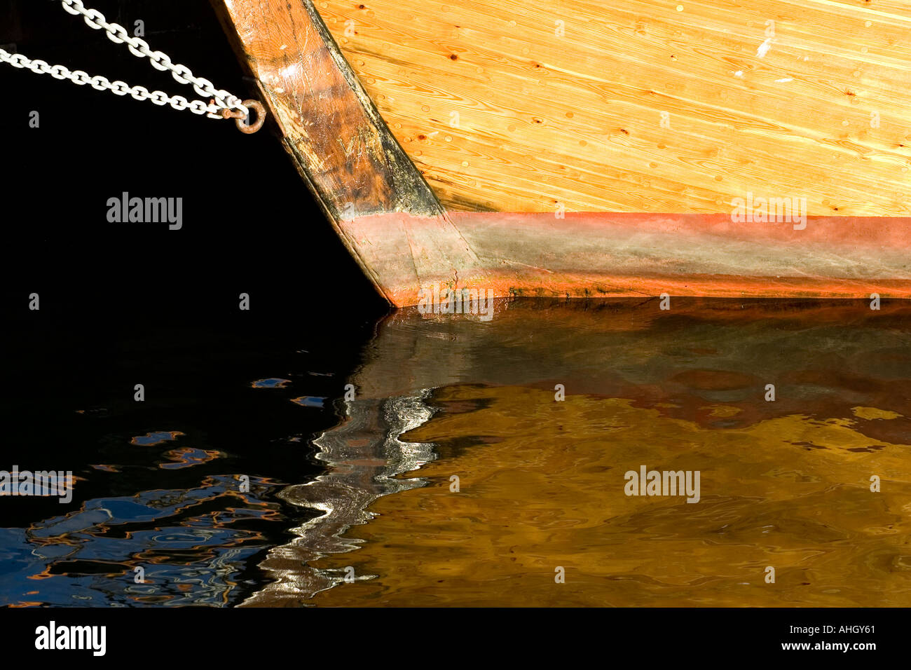 Colorful, graphic image of a sailing ship keel and its reflection on
