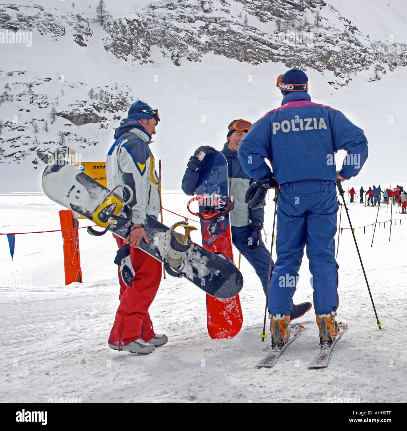 Ski police in Gressonnay Italy having a word with two snowboarders on the  slopes Stock Photo - Alamy