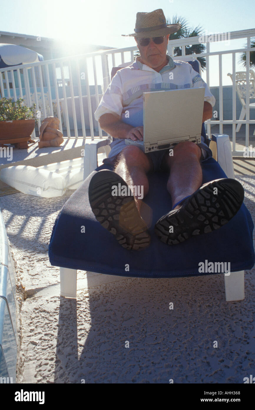 Businessman on vacation keeping in touch with his office Stock Photo