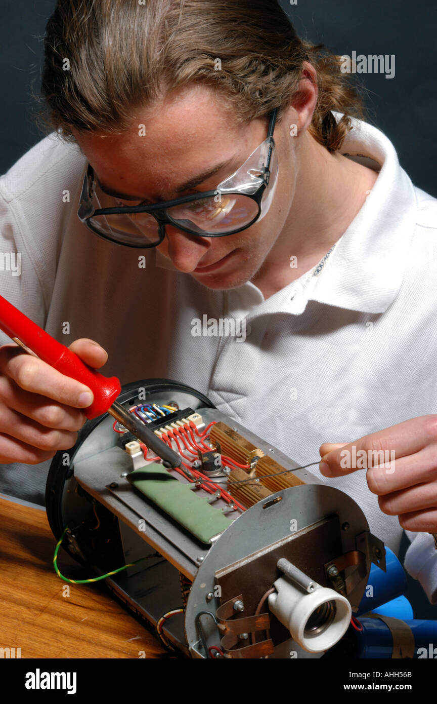 Young man soldering Stock Photo