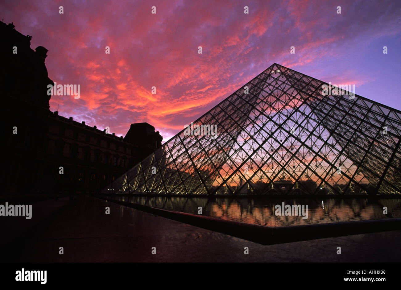 Red sky above The Pyramide at sunset at the Louvre in Paris France Stock Photo