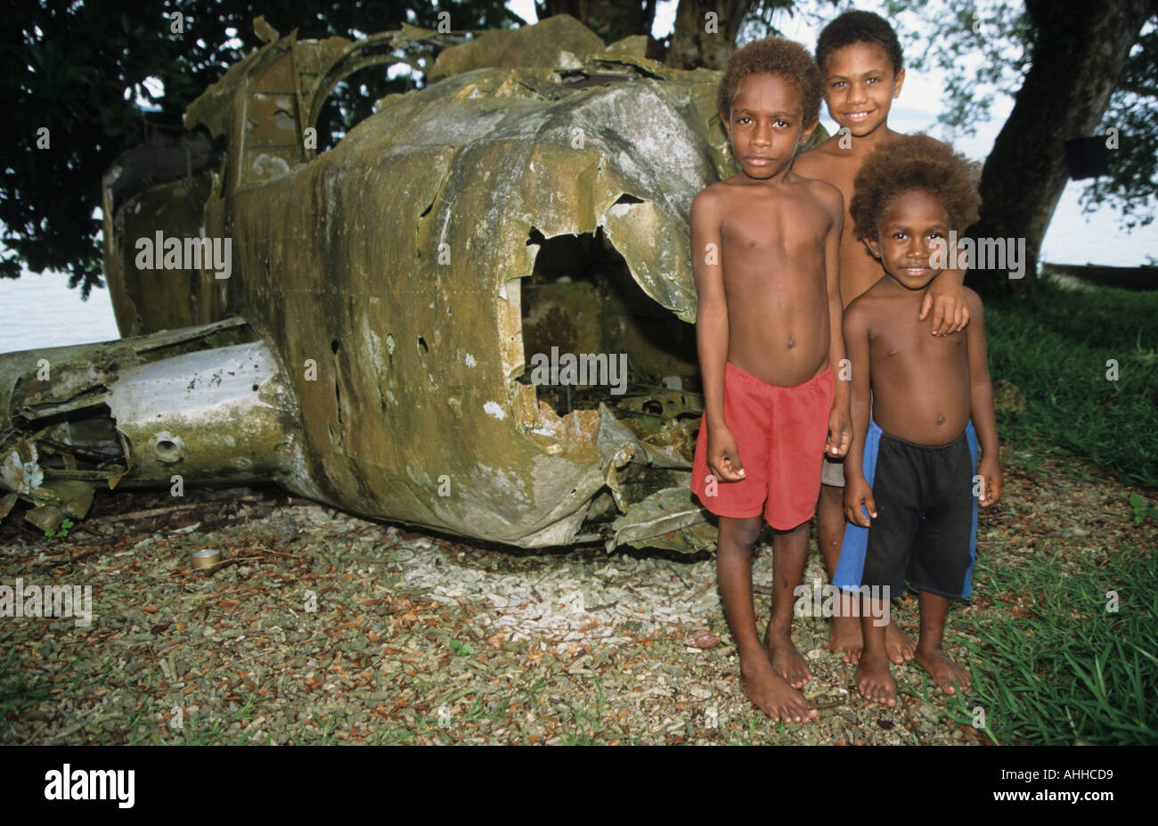 Vanuatu Efate Island Children play by wrecked WW2 US bomber found in lagoon at the capital Port Vila where many crashed Stock Photo