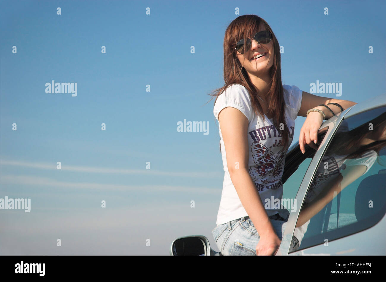Young woman hanging out of car window side view Stock Photo Alamy