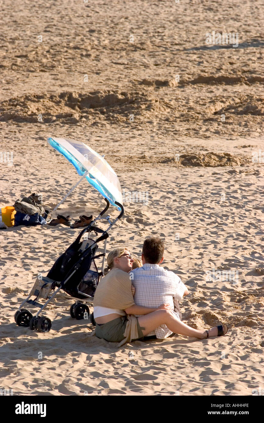 loving couple on a beach with a parasol Stock Photo