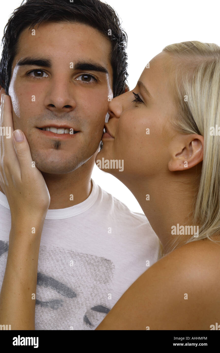 young man kissed by a woman on his cheek Stock Photo