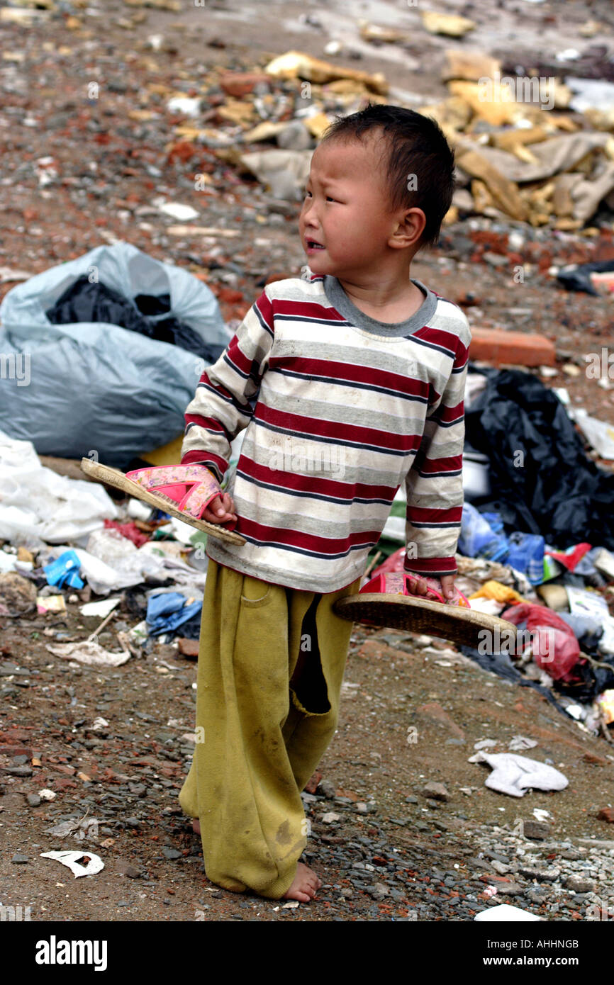 Small Barefoot Homeless Chinese Boy Crying in a Vacant Lot, Shenzhen, China Stock Photo