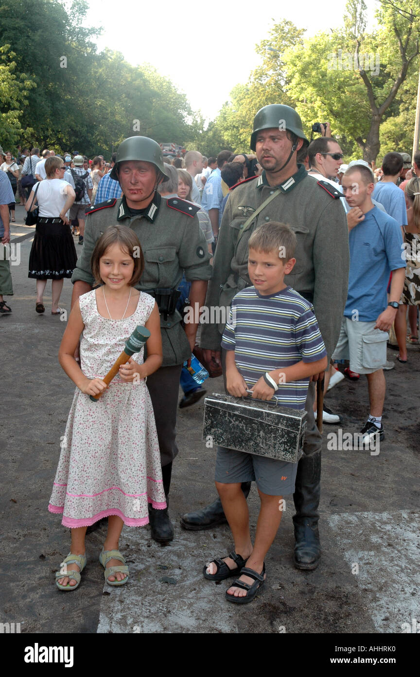 Historical reenactment of Warsaw Uprising in 1944 during II World War - kids taking memorial photo with german soldiers Stock Photo
