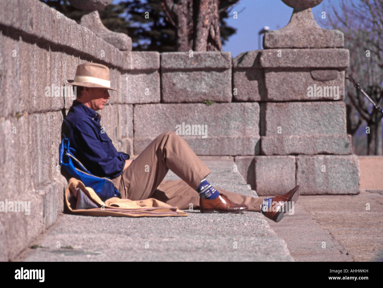 El Escorial, Spain. Man in hat relaxing Stock Photo