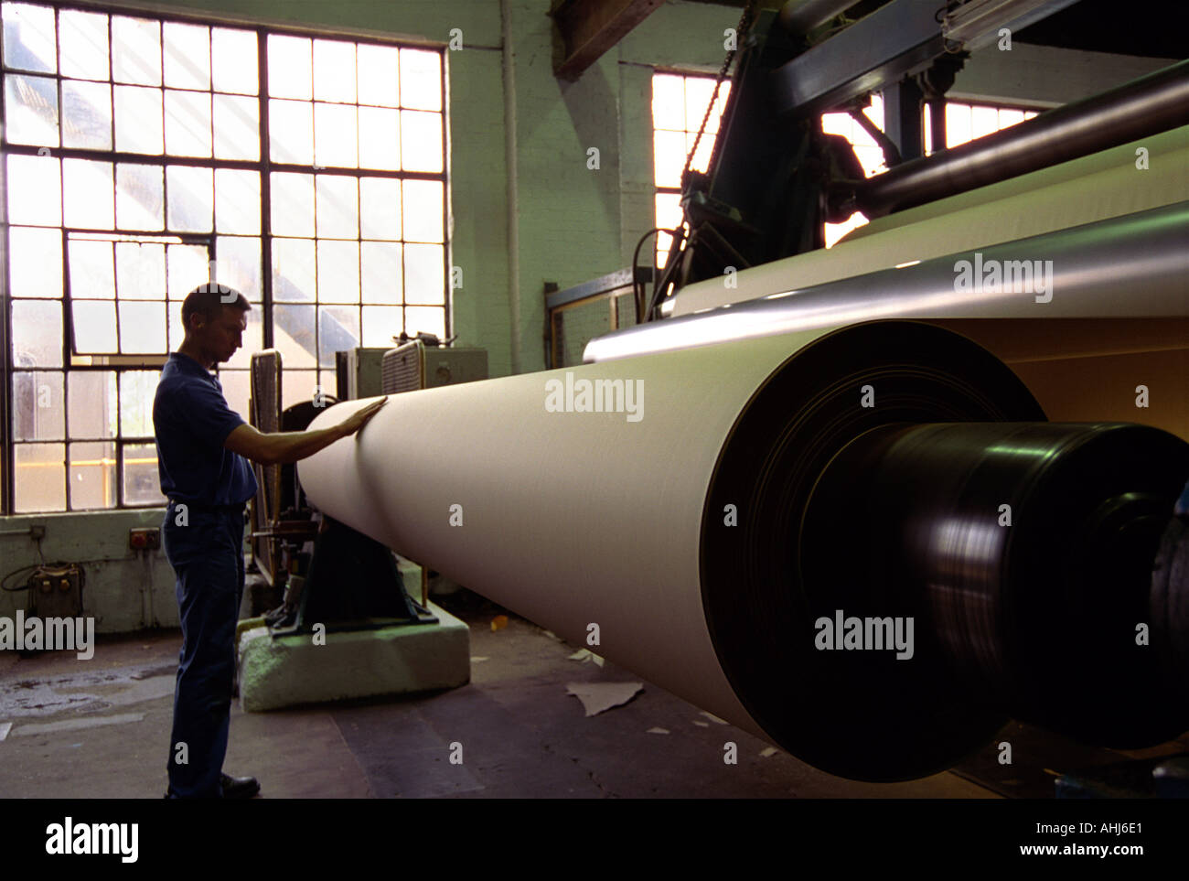 Rolls of paper passing through machines Smurfit paper factory, Snodland, UK Stock Photo