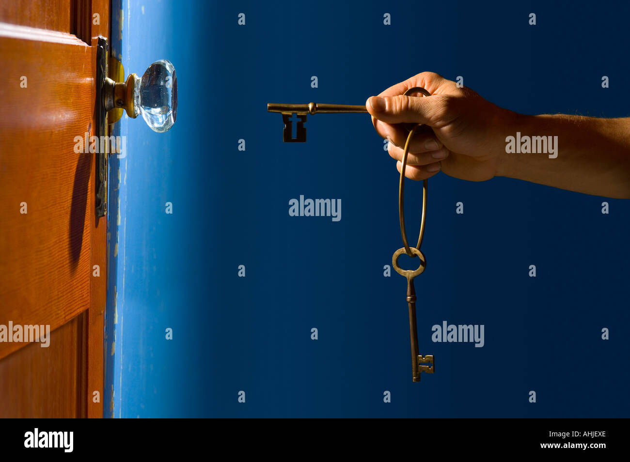 Hand with keys about to open door Stock Photo - Alamy
