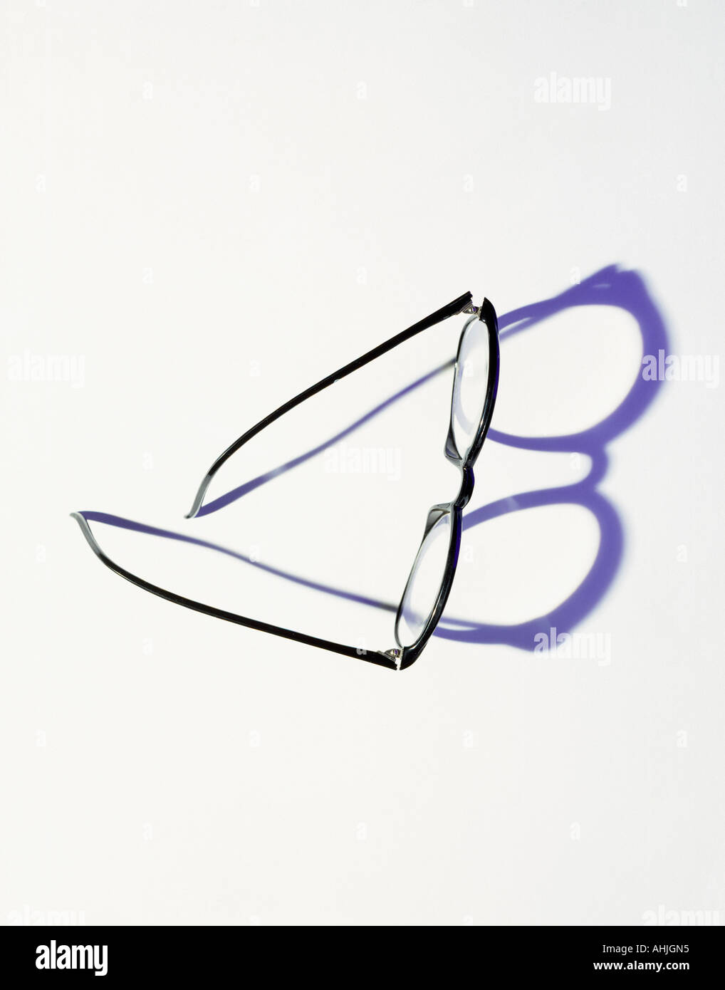 Black glasses casting shadow Stock Photo - Alamy