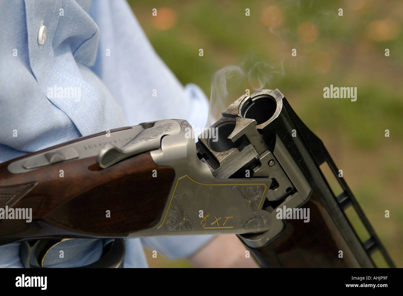 P26 128 Shooting Range, Skeet, Smoke Comes From Chamber Of Recently Fired Shotgun Stock Photo