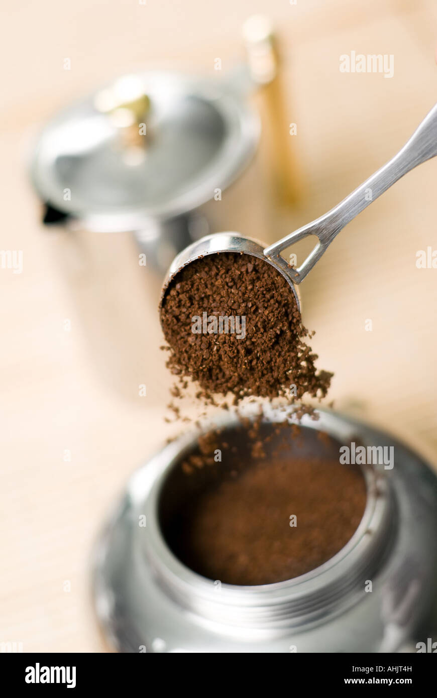 Pouring ground coffee focus on it into coffee maker. Shallow depth of