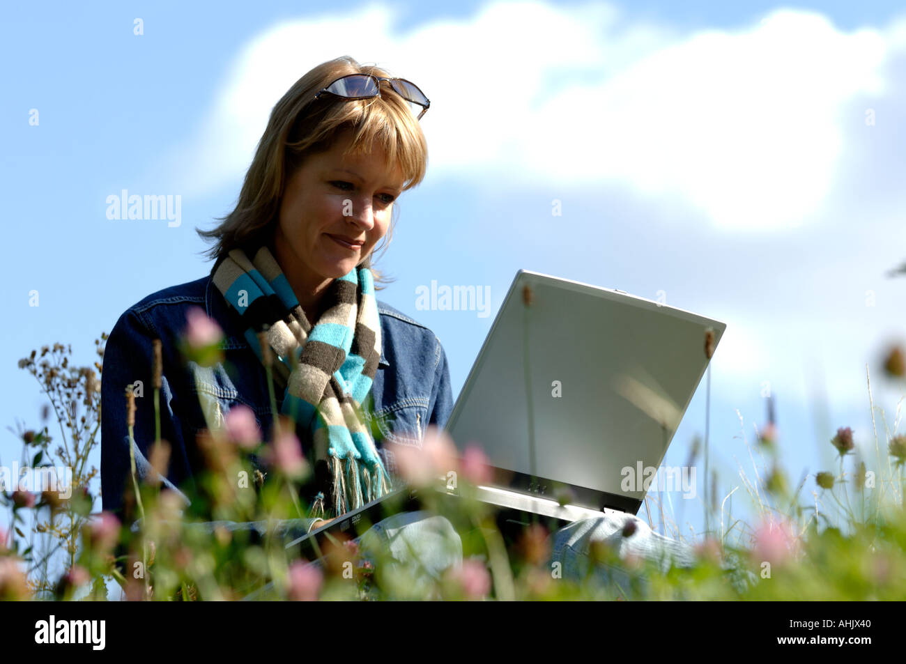 Woman outdoors using a laptop Stock Photo