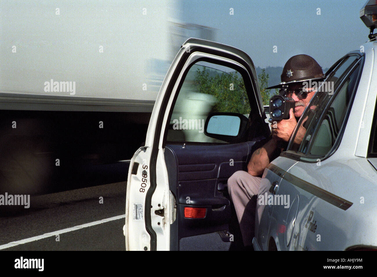 Sheriff using radar gun Stock Photo