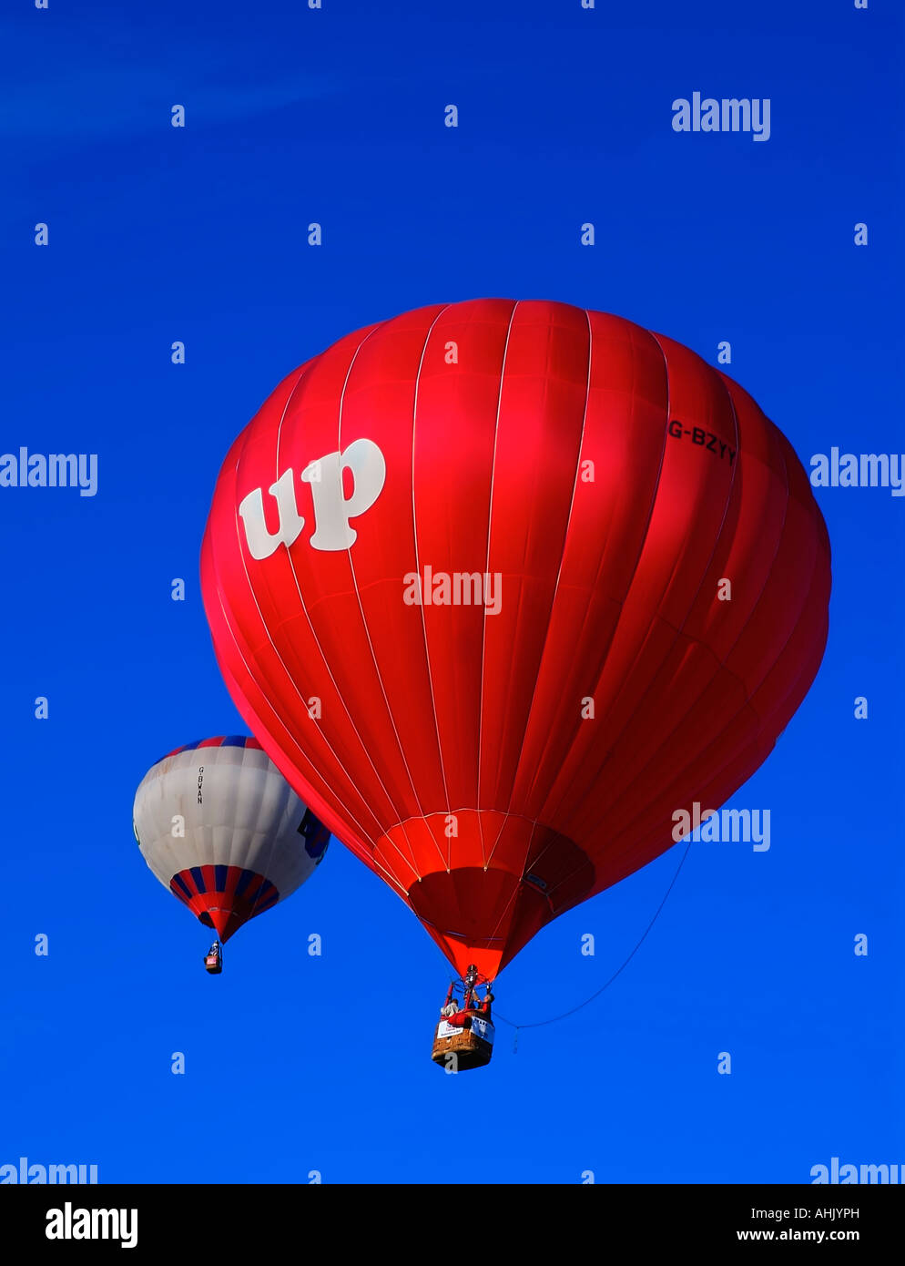 Two hot air balloons in a blue sky Stock Photo - Alamy
