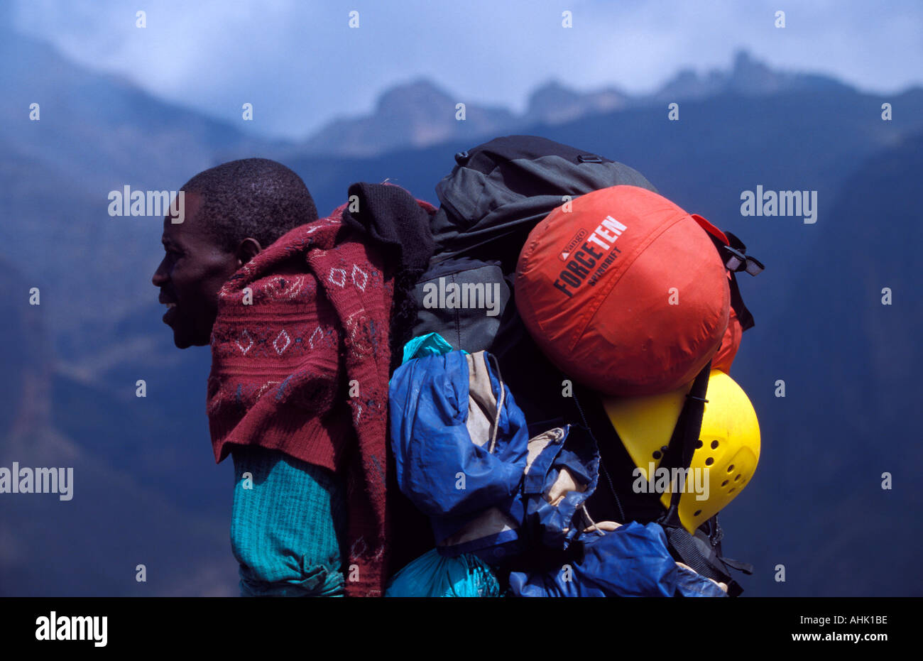 Kenyan porter transporting baggage for mountaineering expedition to