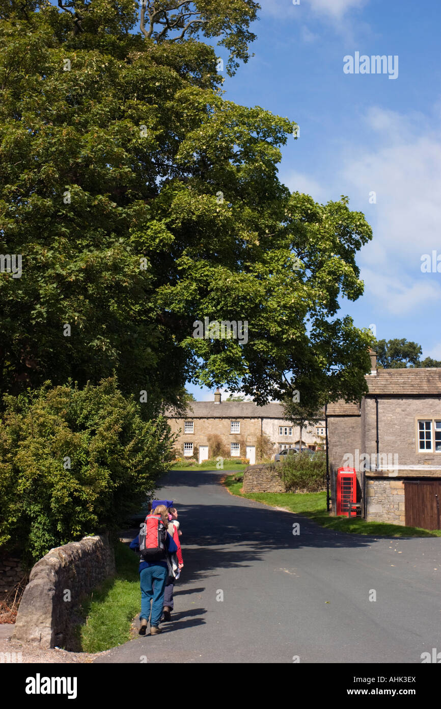 Walkers arriving in the village of Downham in East Lancashire Stock Photo