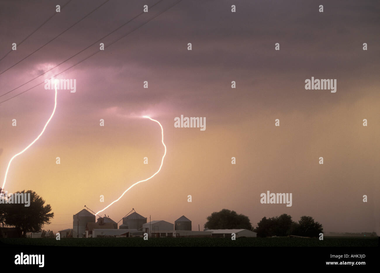 USA Nebraska Hastings Lightning strikes near farm buildings at edge of